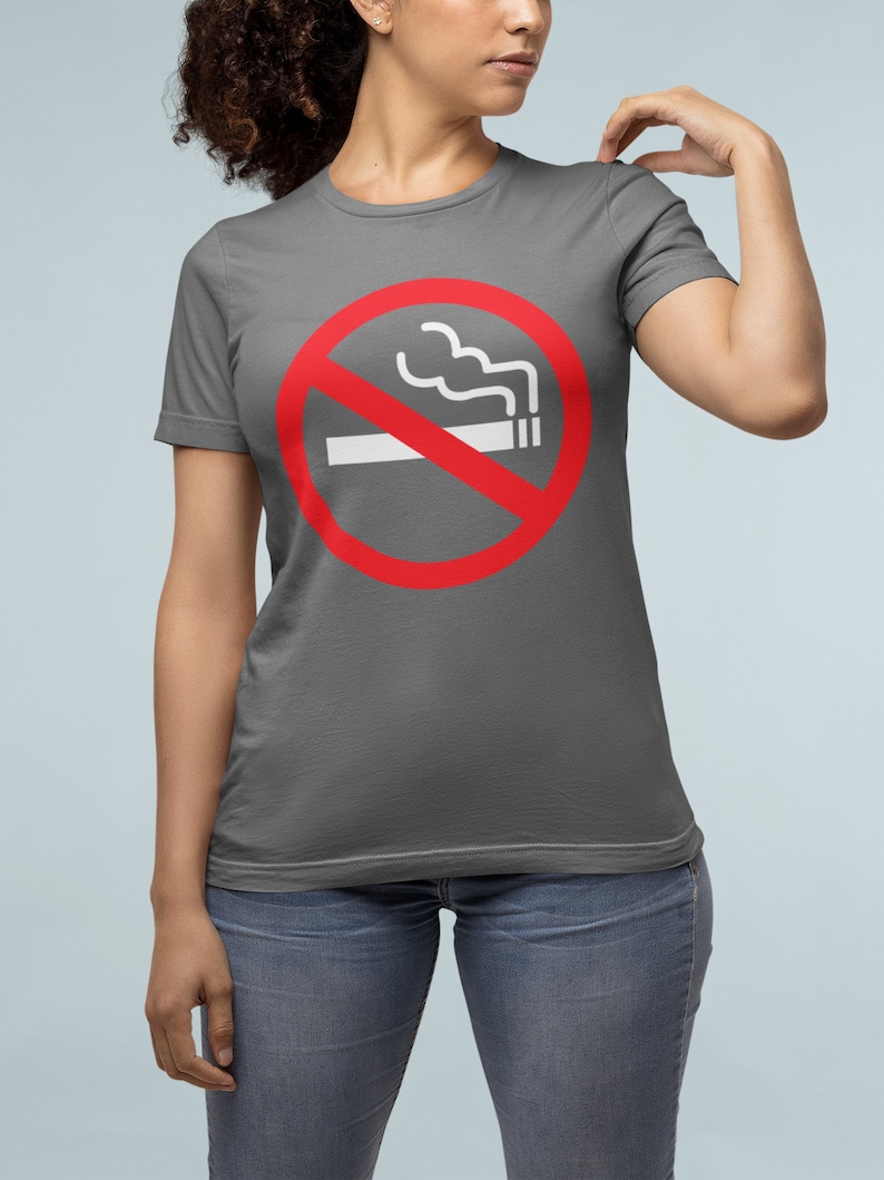 May include: A charcoal gray t-shirt with a red circle and a white line through it. The circle has a white cigarette with smoke coming out of it. The text "No Smoking" is not visible in the image.