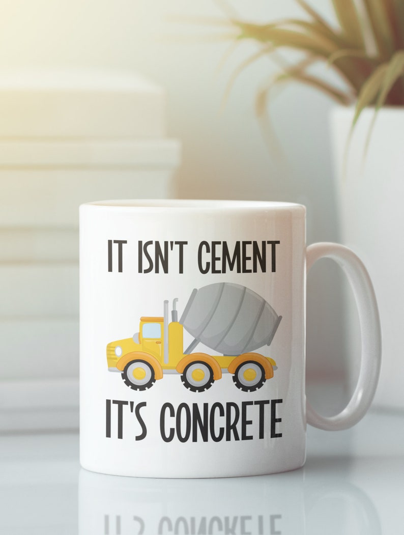 May include: White ceramic mug with a yellow cement truck and the text "It isn't cement, it's concrete".