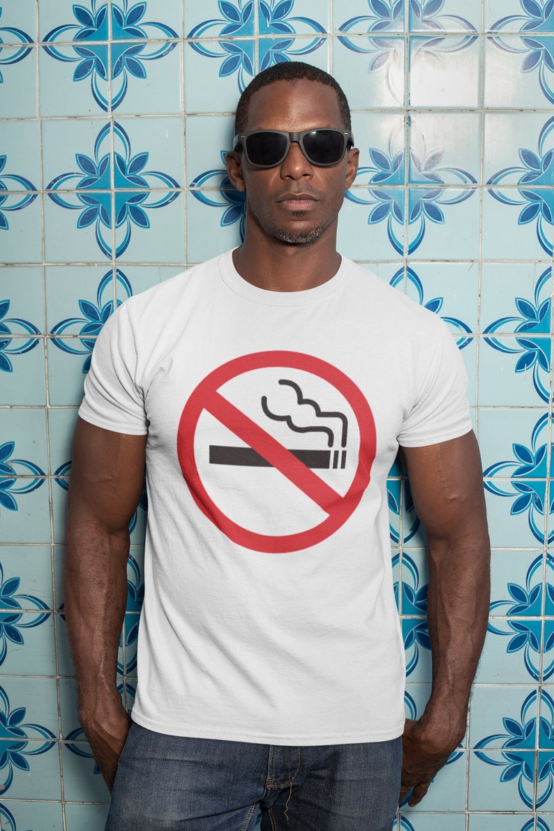 May include: A white t-shirt with a red circle and a diagonal line through it. The circle contains a black cigarette with smoke coming from it. The text "No Smoking" is not visible in the image.