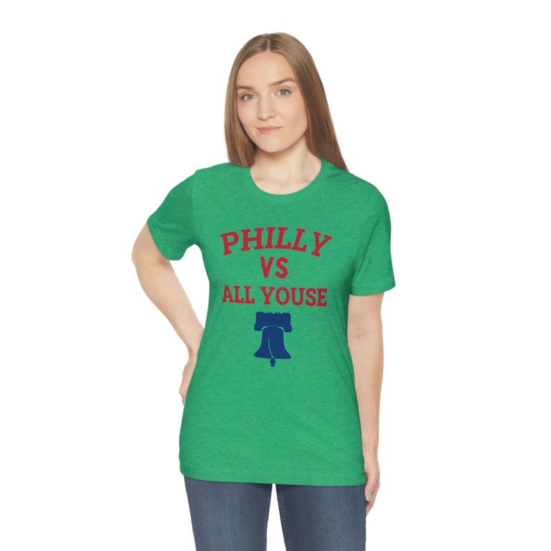 May include: A green t-shirt with the text "Philly vs All Youse" in red and a blue Liberty Bell graphic.