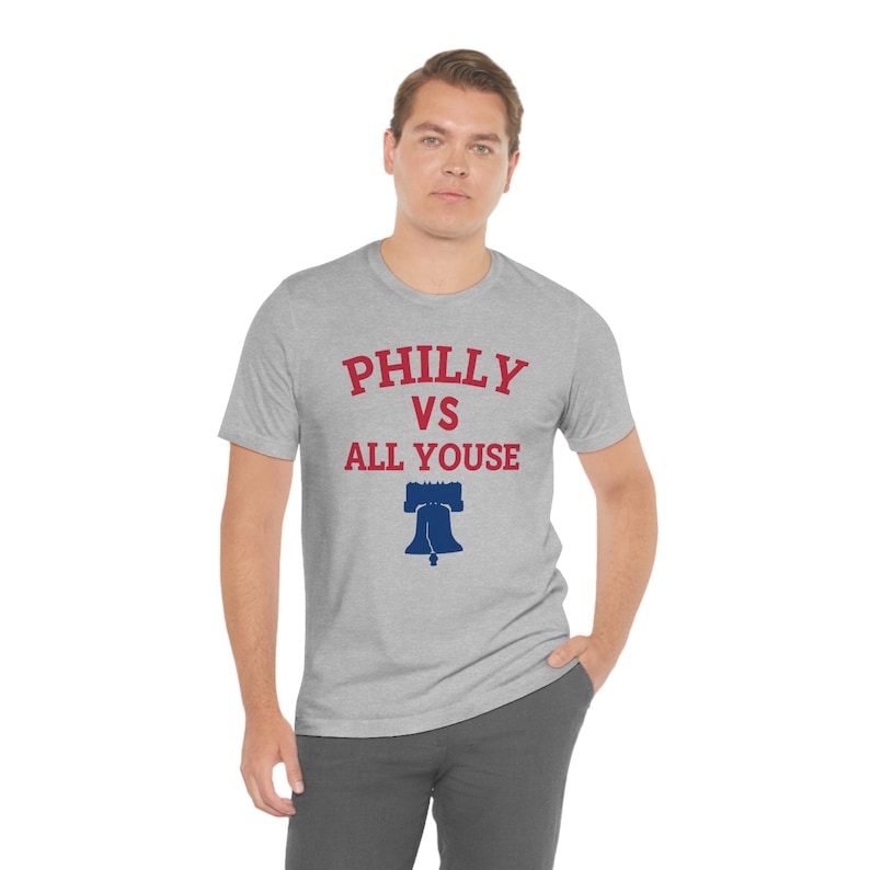 May include: A heather grey t-shirt with a red and blue graphic that says "Philly vs All Youse" and a blue Liberty Bell graphic.