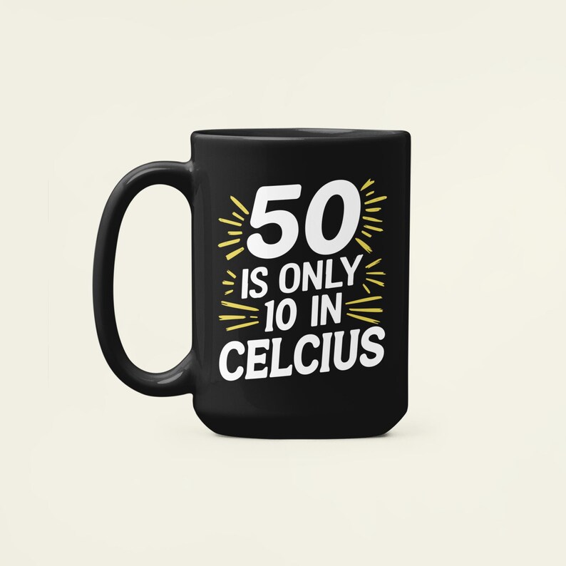 May include: Black ceramic mug with a large handle. The mug features the text "50 is only 10 in Celcius" in white and yellow. The mug is designed for hot drinks and is suitable for everyday use.