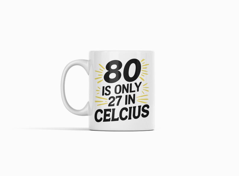 May include: White ceramic mug with the text "80 is only 27 in Celcius" in black and yellow. The mug has a curved handle and is suitable for hot beverages. A fun gift for someone turning 80.