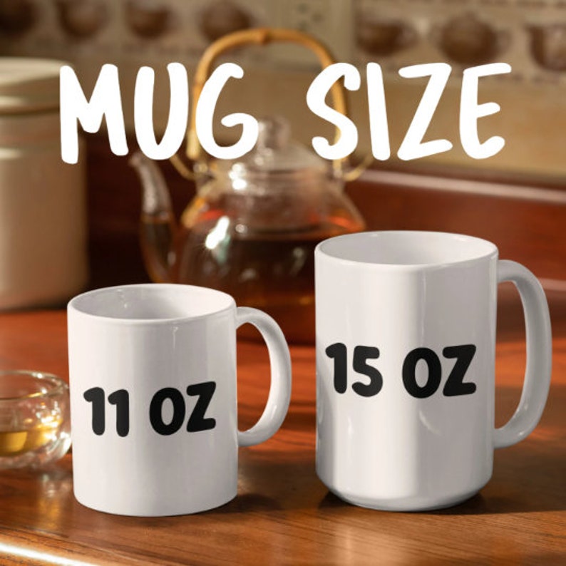 May include: Two white ceramic mugs with black text. The mug on the left says "11 oz" and the mug on the right says "15 oz".