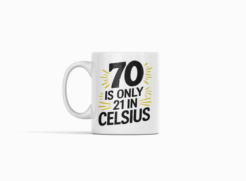 May include: White ceramic mug with a black and gold design. The mug features the number "70" with the text "is only 21 in Celsius". The design includes gold bursts around the numbers and text.