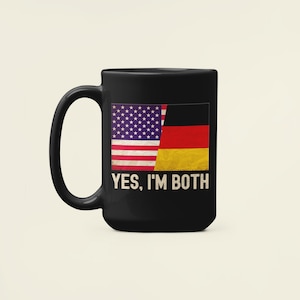 May include: Black coffee mug featuring an American flag and a German flag, with the text "YES, I'M BOTH" printed below.