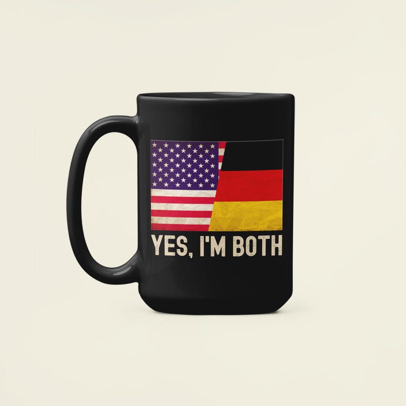 May include: Black coffee mug featuring an American flag and a German flag, with the text "YES, I'M BOTH" printed below.