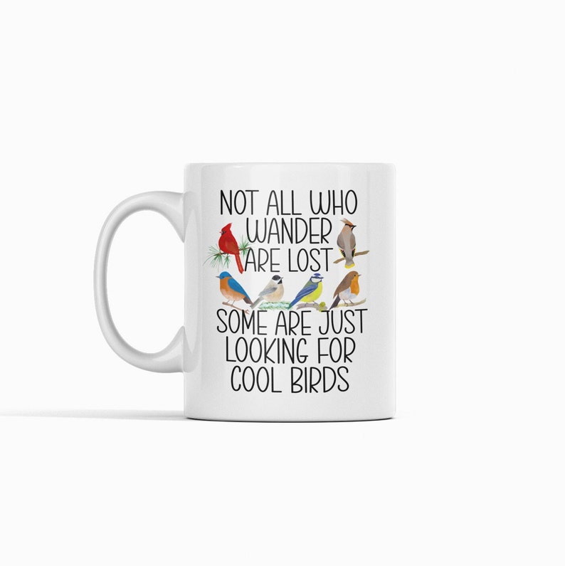 Puede incluir: Taza de cer&aacute;mica blanca con un dise&ntilde;o en blanco y negro que presenta una variedad de p&aacute;jaros y el texto "Not all who wander are lost. Some are just looking for cool birds."