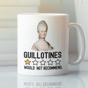 May include: White ceramic mug with a black and white image of a woman with a one-star rating and the text "Guillotines Would Not Recommend."