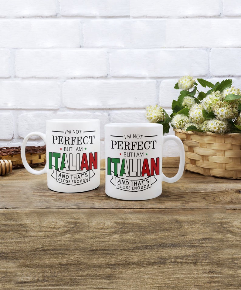 May include: Two white ceramic mugs with black text and red, green, and white accents. The text on the mugs reads "I'm not perfect, but I am Italian, and that's close enough."