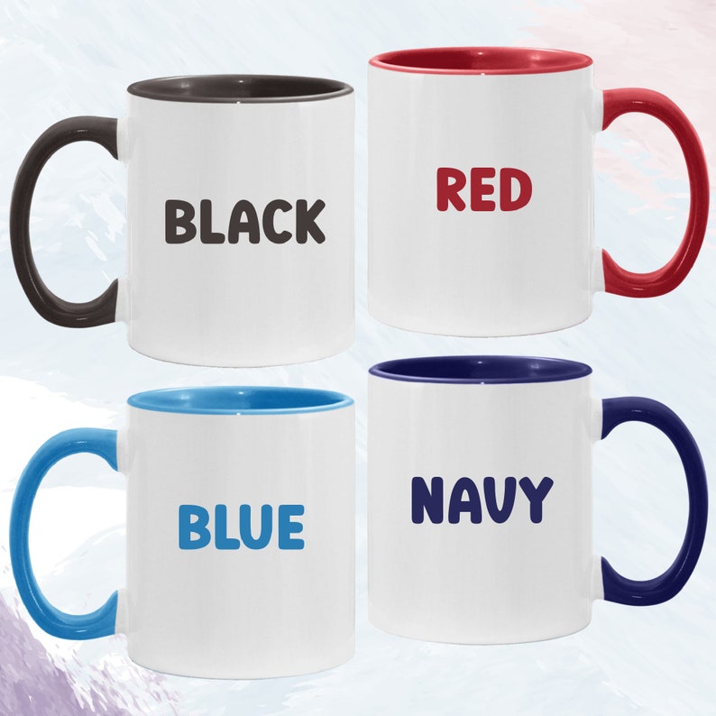 May include: Four ceramic coffee mugs with different colored rims and text. The mugs are black with a black rim, red with a red rim, blue with a blue rim, and navy with a navy rim. The text on the mugs reads "BLACK", "RED", "BLUE", and "NAVY".