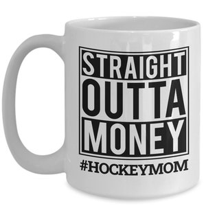 May include: White ceramic coffee mug with a black graphic that reads "Straight Outta Money #HockeyMom".