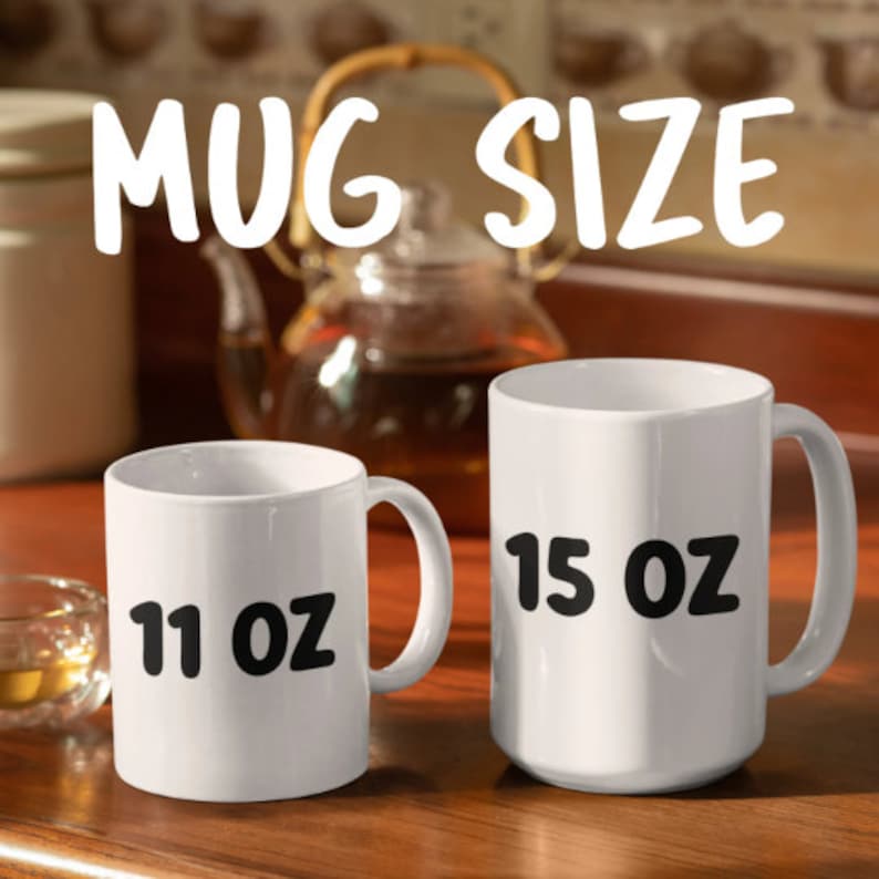May include: Two white ceramic mugs with black text. The mug on the left says "11 oz" and the mug on the right says "15 oz".
