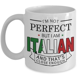 May include: White ceramic coffee mug with a black and green design. The mug has the text "I'm not perfect, but I am Italian, and that's close enough." with a red, white, and green Italian flag design.