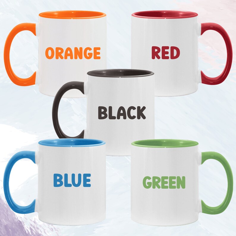 May include: Five ceramic mugs with colored rims. The mugs are white with the words "ORANGE", "RED", "BLACK", "BLUE", and "GREEN" printed in bold, black letters.