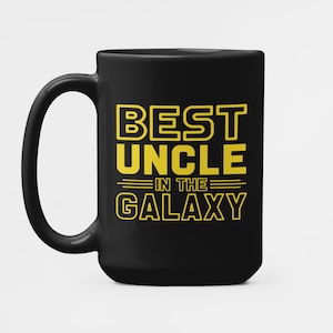 May include: Black coffee mug with a yellow design that says "Best Uncle in the Galaxy".