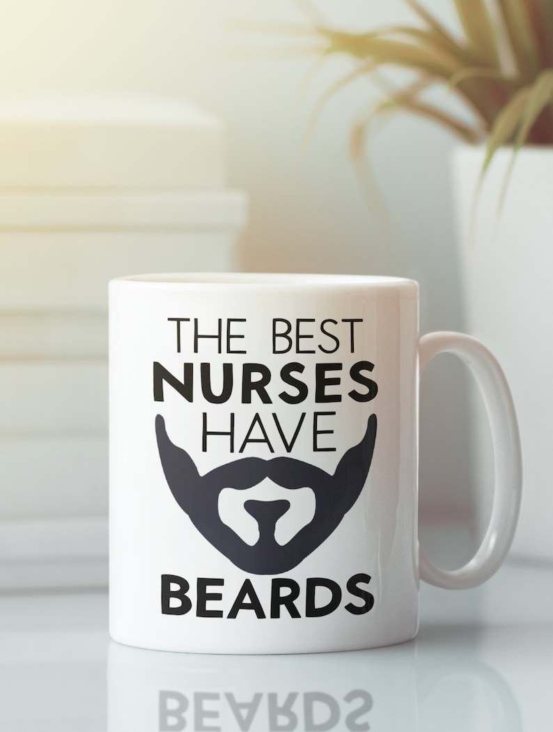 May include: White ceramic mug with black text that reads "The Best Nurses Have Beards" and a black silhouette of a beard.
