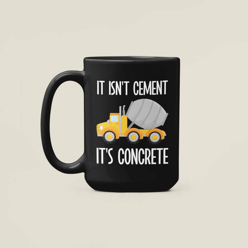 May include: Black coffee mug with a white graphic of a yellow cement mixer truck and the text "It isn't cement it's concrete".