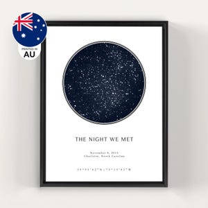 May include: A framed wall art print featuring a circular dark blue star map on a white background. The text reads THE NIGHT WE MET, November 8, 2015, Charlotte, North Carolina, and the coordinates 39 95 42 N | 75 15 03 W. A small Australian flag icon is visible.