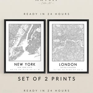May include: Set of two framed black and white map prints. One print features New York City, the other London. The prints include the city name and coordinates. The text "ARTSIF Custom Art" is at the top.