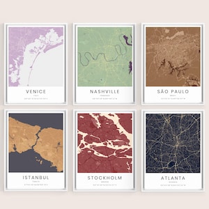May include: Six framed wall art prints featuring stylized city maps of Venice, Nashville, São Paulo, Istanbul, Stockholm, and Atlanta. Each print displays a unique color palette, geographic street layout, and the city name with coordinates below.