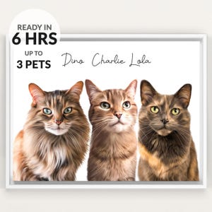 May include: A framed digital portrait featuring three cats with brown, tan, and grey fur. The text reads READY IN 6 HRS UP TO 3 PETS and the names Dino, Charlie, and Lola. The cats are positioned side by side against a plain white background.