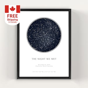 May include: Framed print with a dark blue starry night sky in a circular design. The text "THE NIGHT WE MET" is below the circle, with date, location, and coordinates. A Canadian flag and text "FREE Shipping in Canada" are in the upper left corner.