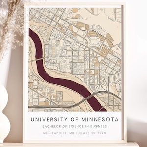 May include: A framed map print of the University of Minnesota campus in Minneapolis, MN. The map features a detailed street layout with a maroon river running through the center. Text at the bottom reads "UNIVERSITY OF MINNESOTA, Bachelor of Science in Business, Minneapolis, MN | Class of 2026."
