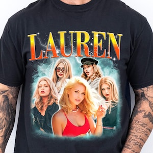 May include: A black short-sleeved t-shirt featuring a graphic print of the name LAUREN in large orange and yellow letters. Below the text are five photographic portraits of a blonde person in various outfits, set against a teal lightning background.