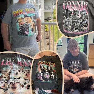 May include: A collection of gray and black t-shirts featuring graphic prints of various dog and cat breeds. The shirts display names like DOG DAD, CONNIE, LIL' MAN, and DOZER in bold, colorful lettering above photographic portraits of pets.