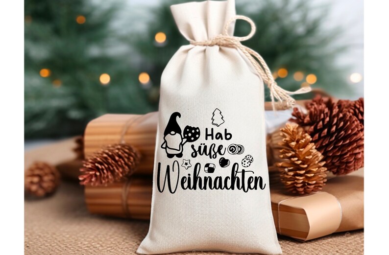 May include: A white fabric gift bag with a black and white illustration of a gnome holding a plate of cookies. The bag has the text "Hab s&uuml;&szlig;e Weihnachten" printed on it.