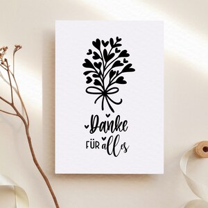May include: A white card with a black illustration of a bouquet of hearts with a bow and the text "Danke f&uuml;r alles".