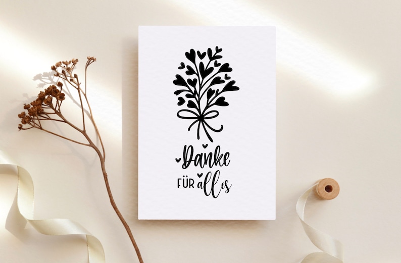 May include: A white card with a black illustration of a bouquet of hearts with a bow and the text "Danke f&uuml;r alles".