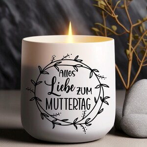 May include: White candle with a black floral wreath design and the text "Alles Liebe zum Muttertag" on the front.