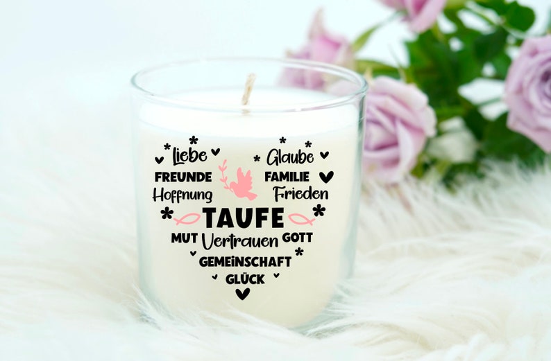 May include: White candle in a glass jar with a black heart design and the words "Liebe, Freunde, Hoffnung, Glaube, Familie, Frieden, Taufe, Mut, Vertrauen, Gott, Gemeinschaft, Gl&uuml;ck" in German.