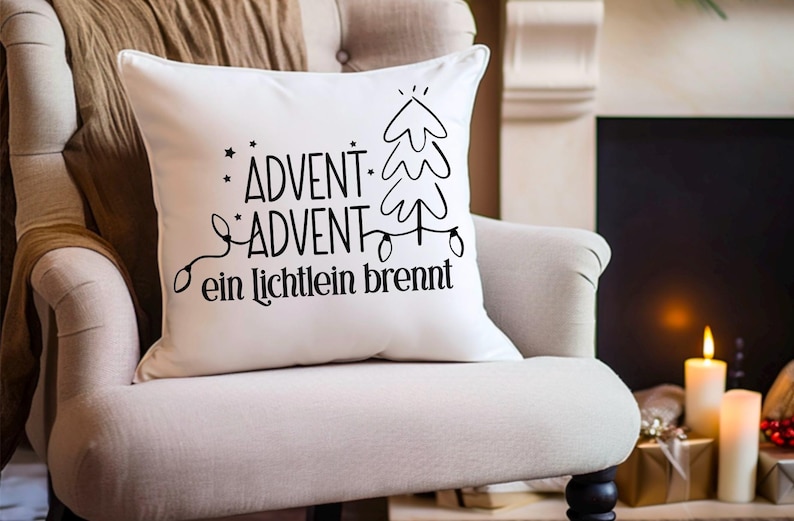 May include: White throw pillow with black text that reads "Advent - Advent ein Lichtlein brennt" and a stylized Christmas tree with lights.
