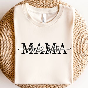 May include: A white t-shirt with the text "MAMA die beste" in black lettering with a heart symbol.