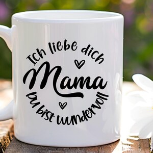 May include: White ceramic mug with a black design that says "Ich liebe dich Mama du bist wundervoll" which translates to "I love you Mom you are wonderful".