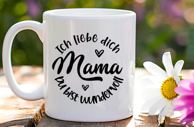 May include: White ceramic mug with a black design that says "Ich liebe dich Mama du bist wundervoll" which translates to "I love you Mom you are wonderful".