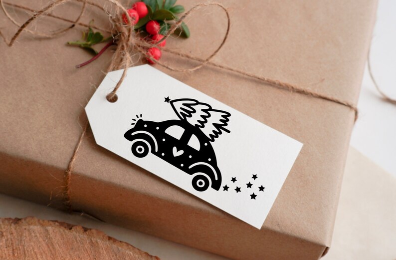 May include: A black and white illustration of a car with a Christmas tree on top. The car is decorated with white dots and a heart. There are stars behind the car.