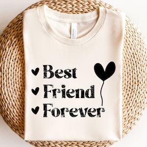 May include: A white t-shirt with black text that reads "Best Friend Forever" with a black heart balloon graphic.