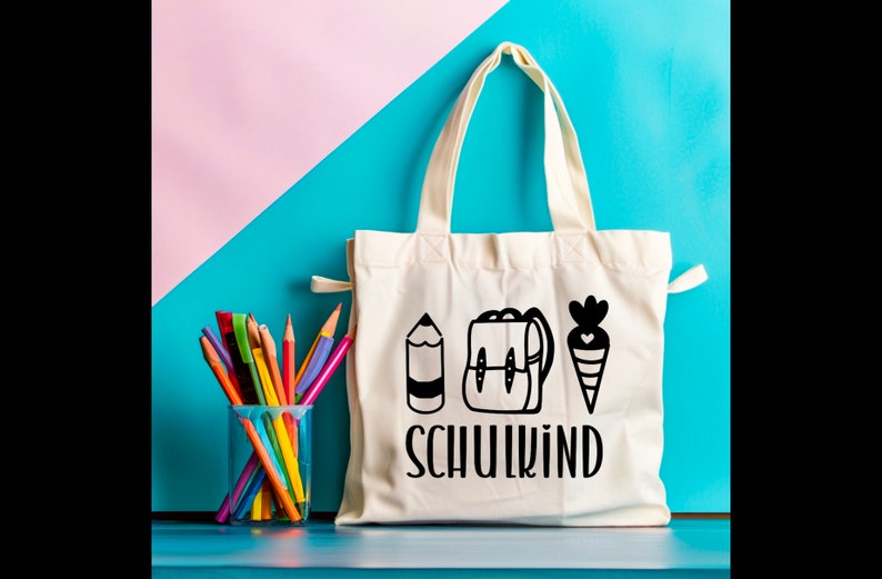 May include: White canvas tote bag with black illustrations of a pencil, backpack, and carrot. The text "SCHULKIND" is printed in black below the illustrations.