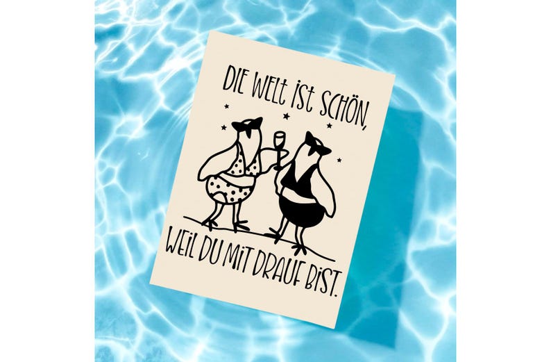May include: A beige card with black text and illustrations floats on blue water. The card features two cartoon birds, one in a polka-dot swimsuit and the other in a tuxedo, with the German phrase "Die Welt ist sch&ouml;n, weil du mit drauf bist."