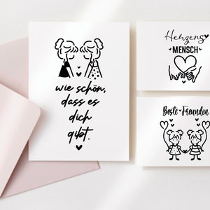 Puede incluir: Tres tarjetas con ilustraciones en blanco y negro y texto. La primera tarjeta dice "wie sch&ouml;n, dass es dich gibt.". La segunda tarjeta dice "Herzens Mensch" con un coraz&oacute;n y dos manos que lo sostienen. La tercera tarjeta dice "Beste Freundin" con dos figuras de palo que se toman de la mano.