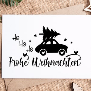 May include: A white card with black text and a black silhouette of a car with a Christmas tree on top. The text says "Ho Ho Ho Frohe Weihnachten".