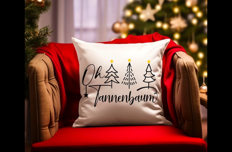 May include: White throw pillow with black text that reads "Oh Tannenbaum" and three stylized black Christmas trees with gold stars on top.