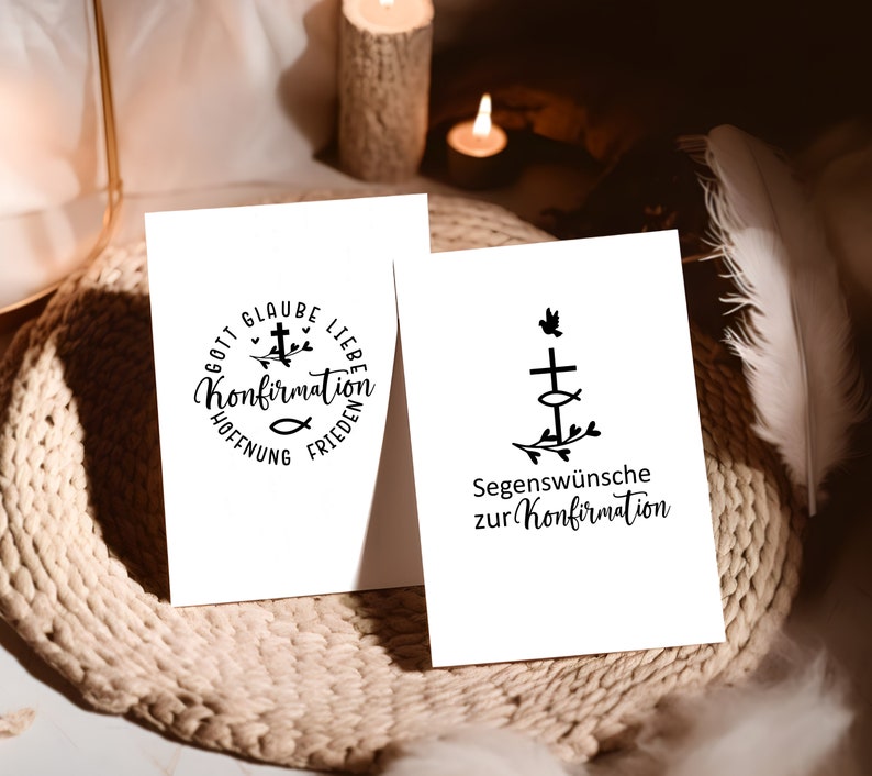 May include: Two white cards with black ink designs. The first card has a circle with the words "Gott Glaube Liebe Hoffnung Frieden" and a cross with a fish and leaves. The second card has a cross with a fish and leaves and the words "Segensw&uuml;nsche zur Konfirmation".