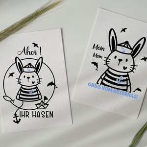 May include: A black and white illustration of a rabbit dressed as a sailor with the text "Ahoi!" and "Ihr Hasen" on a white background.