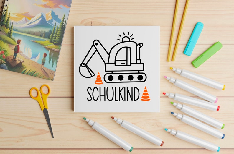 May include: A white notebook with a black and white illustration of an excavator with orange traffic cones. The text "SCHULKIND" is written below the excavator.