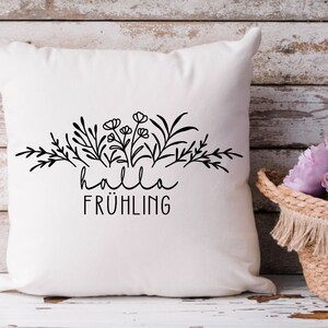 May include: White pillow with black floral design and the text "hallo fr&uuml;hling" printed on it.